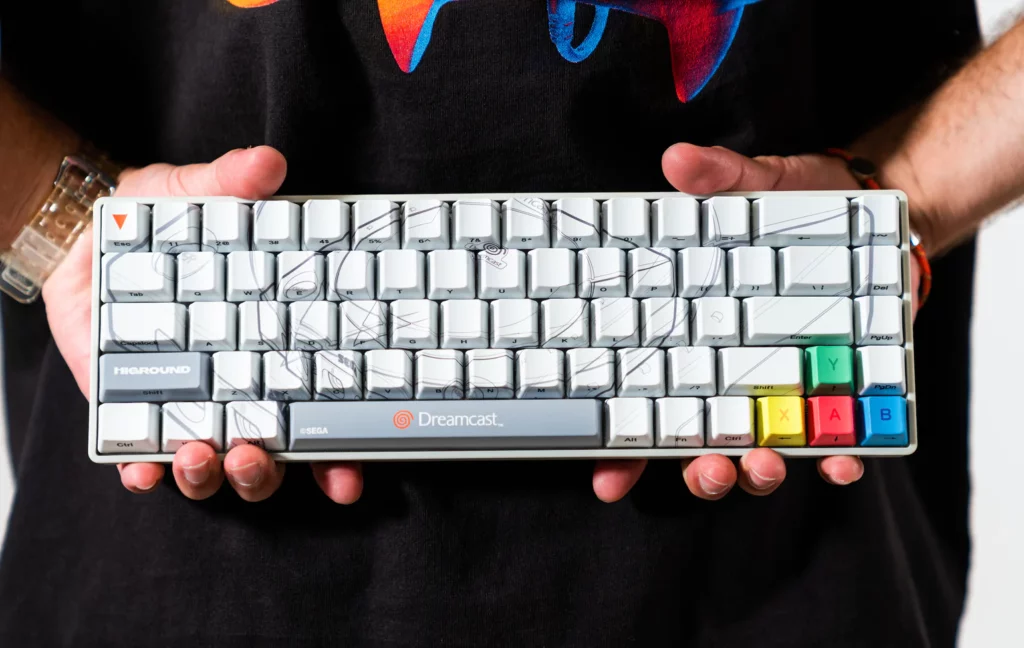 Dreamcast-themed keyboard with white keycaps and the outline of a Dreamcast drawn on.